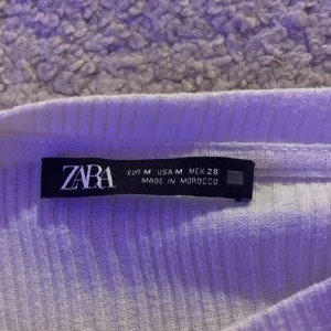 Vit Långarmad volang tröja ZARA - Jätte fin vit långarmad volang tröja köpt ifrån zara! Säljer pågrund av att den inte riktigt känns som min stil längre! Är i Nyskick och Nypriset var 199kr! Storleken är  i M men passar mig som vanligtvis har XS/XXS! Kontakta mig vid intresse! 