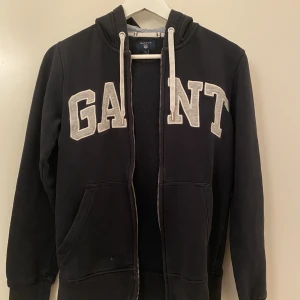 Gant zip up hoodie  - Säljer denna fina Gant zip up hoodie för 320kr. Den är i storlek XS och är svarta/mörkblå, pris kan förhandlas🤍 