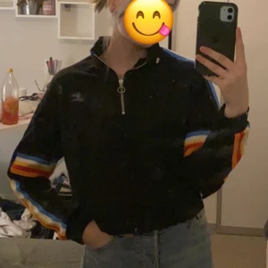 Svart tröja med regnbågsarmar - Bra skick, inte använd många gånger. 