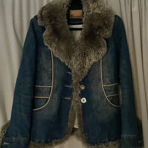 Y2K jeansjacka - Ashärlig jacka i jeans, väldigt Y2K. Man kan ta bort innefodret i jackan, så man kan ha den både på vinter och sommaren. Lite trasig inne men det går lätt att fixa med sytråd. En av knapparna är borta, och en annan är trasig. Den tredje sitter kvar! 