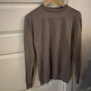 Beige stickad tröja John Henric - Snygg beige stickad tröja från John Henric i storlek M. Tröjan har en klassisk rund hals och långa ärmar, perfekt för lager på lager. Materialet är mjukt och skönt, och färgen är neutral vilket gör den enkel att matcha med andra plagg. Passar M/S