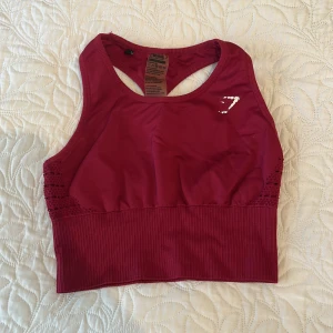 Träningstopp gymshark - Superskön träningstopp från gymshark. Väldigt bra skick utöver att loggan på framsidan börjat lossna. Vadderingen är utplockad 🫶