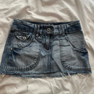 Blå jeanskjol med rå kant - Säljer en kort jeanskjol i klassisk blå tvätt med slitna detaljer, säljer denna på vinted också så det är först till kvarn som gäller💓💓midjemåttet:34cm, längden är:27cm