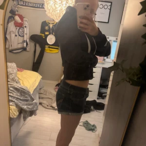 Mörkblå jeansshorts med rå kant - Snygga mörkblå jeansshorts med rå, fransig kant nertill och klassiska kontrastsömmar. Shortsen har låg midja och bakfickor med dekorativa sömmar. Perfekta för sommaren och riktigt sköna att bära till en hoodie eller t-shirt.