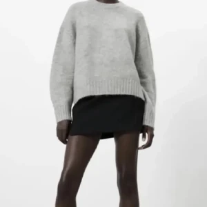 Grå stickad tröja med rund hals - Säljer en enkel och stilren grå stickad tröja med rund hals och långa ärmar. Tröjan har en avslappnad passform och bred ribbstickning vid ärmslut och nederkant. Perfekt för lager-på-lager och passar till det mesta.