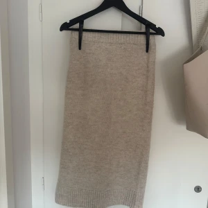 Kjol🤍 - Mysig beige stickad kjol från VILA med ribbad kant nertill och en liten slits på sidan. Fint skick och inte användigt slitit, skriv vid intresse eller funderingar!🙏