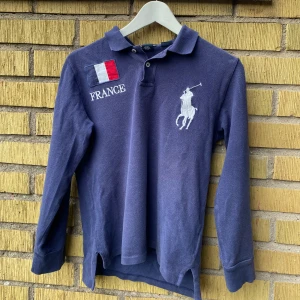 Blå långärmad pikétröja från Ralph Lauren - Säljer denna snygga pikétröja från Ralph lauren. Köpt begagnad men är äkta och är i ganska bra skick för att vara ganska använd. Ställ gärna frågor om de behövs😊