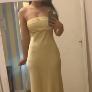 Gul axelbandslös klänning - Säljer nu min helt nya balklänning då jag köpte flera och inte hann lämna tillbaka den i tid. Köpt från Abercrombie & Fitch och är en gul bandouklänning, perfekt inför balen. Klänningen är alltså helt oanvänd med lappen kvar. Fler bilder finns vid förfrågan!