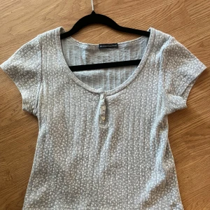 Söt topp från Brandy Melville - Supersöt blå topp från Brandy Melville med små vita blommor och ribbat material. Perfekt till jeans eller kjol nu lagom till sommaren! One size, mycket bra skick.
