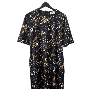 Mönstrad kortklänning från Isay - Kortklänning från Isay med coolt abstrakt mönster i svart, blått, beige och vitt. Klänningen har korta ärmar, rund hals och dragkedja bak. Perfekt för dig som gillar en avslappnad men ändå snygg stil.