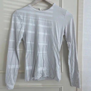 KÖP FRÅN MIN VINTED - Enkel och stilren vit långärmad tröja i mjukt bomullsmaterial. Perfekt att ha som basplagg och funkar till alla outfits. Tröjan har rund halsringning och en tightare passform som sitter snyggt på kroppen.