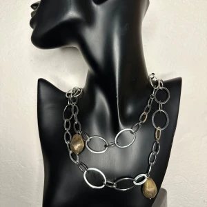 Chunky vintagehalsband i silver, brons och guld - 100 cm långt - 00-tal - Från svenska Miss Dee  - Fantastisk statement-halsband från Miss Dee i metall med mässings- och guldfärgade hängen. Ca 100 cm långt med länkar upp till 1,2 cm och hängen upp till ca 2 cm. Sannolikt från 2000-talet, inropat på auktion med äldre silversmycken & bijouterier. Kan vara Silverpläterat, men ej testat.  Bär det långt, dubbelvikt eller som lager-på-lager.  Ingen prutning – men jag erbjuder bundlerabatt! Kolla gärna mina andra annonser – jag rensar garderob och smyckesskrin. 