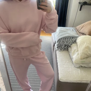 Ljusrosa hoodie + mjukisbyxa från Gina tricot  - Mysig ljusrosa hoodie + mjukisbyxa från Gina med klassisk känguruficka och huva. Byxorna är i storlek S och tröjan xs. Använd några fåtal gånger. Om du enbart vill ha hoodien -> 230 (360kr nypris)                                                                       Om du enbart vill ha byxorna -> 220kr (300kr nypris)                                                                                 Om du vill ha båda tillsammans -> 400kr (660kr nypris) 