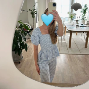 Blårutigt set, blus med tillhörande byxa - Set från Envi.  Blåvitt rutigt mönster med blus som har smock över bysten och volang nertill samt ett par raka byxor. Storlek S, true to size och superskönt.