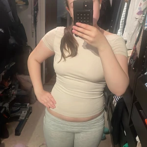 Beige tight topp med öppen rygg - Säljer en beige tight topp med korta ärmar och en djup, öppen rygg. I bilden har jag ingen bh, materialet är bra för att kunna gå utan. 