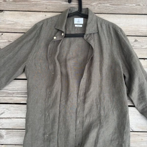 Grön 100% linneskjorta från Bläck - Skjortan är endast använd ett fåtal gånger. I prencip i nyskick! Priset kan diskuteras vid snabb och smidig affär. Nypris: 799kr. 