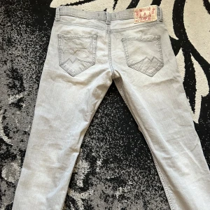 Mustang jeans - Snygga grå jeansbyxor med en klassisk femficksdesign. De har broderade detaljer på bakfickorna och en knappgylf. Perfekta för en stilren look.