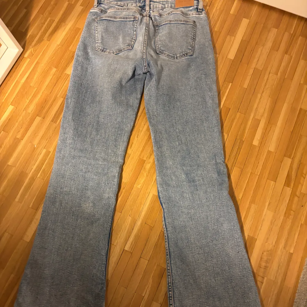 Säljer ett par ljusblåa bootcut jeans från Gina tricot då dem blivit försmå. Byxorna är snyggt slitna nertill och har en snygg passform. . Farkut & Housut.