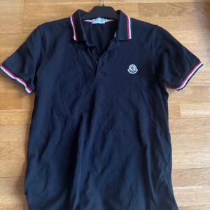 Svart Moncler Pikétröja - Svart Moncler Pikétröja storlek M i mycket bra skick. Skriv för frågor