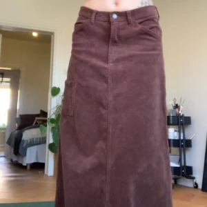 Brun manchesterkjol med fickor - Snygg brun lång manchesterkjol med fickor på sidorna och en bak. Köpt från brandy melville en gång i tiden och märket är j galt, tror dock inte den säljs längre. Inte använt den så mycket och rensar min garderob så därav säljer jag 🤗 Står S på storleken men är nog ett litet mellanting av s/m.