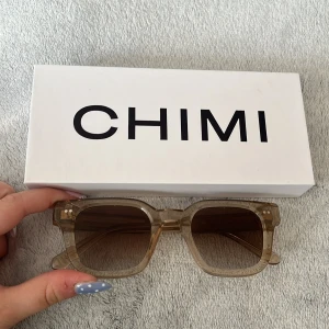 Beige fyrkantiga solglasögon från CHIMI - Snygga solglasögon från CHIMI i modellen 04 Ecru. De har en fyrkantig form och är tillverkade i transparent beige plast med bruna tonade glas. Perfekta för våren och sommaren!! Aldrig använda köpta för 1250kr🩷🩷🩷