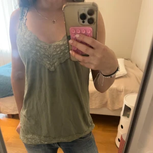 Grönt linne med spets  - Säljer en olivgrön linnetopp med super fin spets från NOA NOA i storlek M 