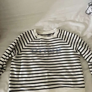 Randig tröja Zadig & Voltaire S - Snygg vit och svart randig tröja från Zadig & Voltaire i storlek S. Tröjan har långa ärmar och texten 'PUNK' framtill i glittriga paljetter. Perfekt för dig som gillar en cool och avslappnad stil.