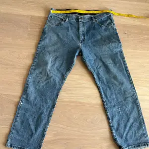 Klassiska blå jeansbyxor med en rak passform. Byxorna har en traditionell femficksdesign och en knappgylf. Perfekta för en avslappnad stil.