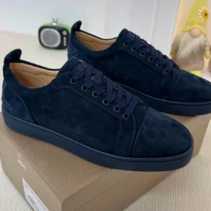 Christian Louboutin  - Snygga mörkblå sneakers från Christian Louboutin i mjuk mocka med ton-i-ton snörning och broderad logga bak. Skorna har en klassisk låg siluett och platt sula, perfekt för en stilren och lyxig look.