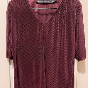 Ny topp strl M - Vinröd / burgundy kortärmad topp i strl M. Helt ny, aldrig använd. Material: 100% polyester 