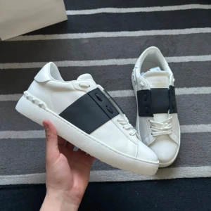 Valentino Opens -  Svart Strip/Black Strip - Helt nya Valentino Open Sneakers med svart stilren stripe. Skorna är oanvända och levereras komplett dustbags och Valentino äkthetskort. Allt originaltillbehör följer med. Perfekta skor för sommaren. Vid frågor är du varmt välkommen att kontakta mig!