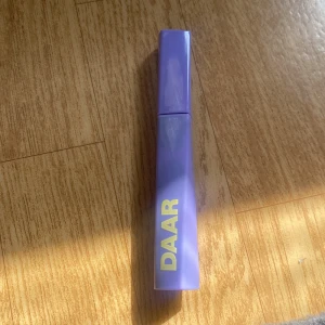 Lila mascara från DAAR - Snygg lila mascara från DAAR med en stilren design. Perfekt för att ge dina fransar volym och längd. Kompakt och lätt att ta med i väskan. Helt ny får även förpackning