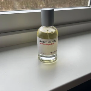 Norrish 420 Eau de Parfum - Säljer en flaska Norrish 420 Eau de Parfum. Flaskan är genomskinlig med en enkel och stilren design. Parfymen har en ljusgul nyans och kommer med en grå kork. Perfekt för den som söker en unik doftupplevelse.