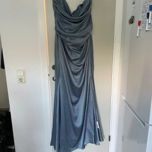 Dubblett blå sidenklänning  - Ny och oanvänd blå sidenklänning i mermaidstil, bandeau. Nypris 1569kr slutsåld på hemsidan  Köpt dubbletter av samma klänning i samma storlek, finns annan annons för den andra!
