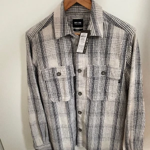 Only & Sons Scott Overshirt - Fin overshirt i bomull som säljes då den inte kommit till användning. Helt ny med prislappen kvar! Färgen är "off white/dark blue" och storleken är medium, brukar även bära den storleken på andra plagg. Nypris 499:-