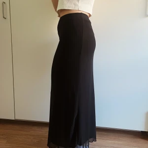 Svart Långkjol - Säljer denna då jag köpt en ny men den är superfin och skön, har ett meshtyg ovanpå ett annat som man kan se i botten vilket gör den unik. 