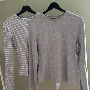 Två st tunna ribbstickade tröjor från Bikbok. En grå enfärgad och en grå med vita ränder. Båda storlek XL. Säljs som ett set. Använda ett fåtal gånger, i nyskick.