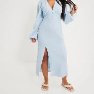 Gina tricot klänning - Super fin klänning från Gina tricot som är perfekt nu till sommaren. Säljer då den tyvärr har blivit lite för kort. Endast använd en gång. Men den har tyvärr tappat en av knapparna, inget man tänker på men därav sänks priset lite. Så fin blå färg. 