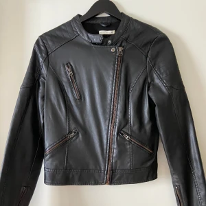 Skinnjacka  - Svart skinnjacka med coola axeldetaljer, strlk 36! Bra skick, knappt använd. 