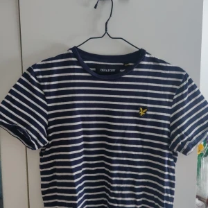 Blå- vit randig Lyle & Scott  - En t-shit från Lyle & Scott, marinblå och vit märket är gult. Passar till det mesta och på de flesta💗