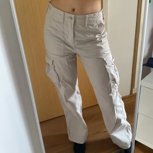 Nya Cargobyxor  - Ej använda ljusbeiga cargobyxor från Bershka. Coola fickor samt justerbar midja. Storlek: 38. 