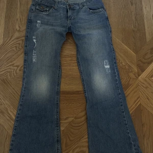 Bootcut baggie jeans - Jättecoola bootcut jeans som är lite baggie med lite slitningar och coola fickor. Finns en liten fläck som syns på tredje bilden men ingen stor.