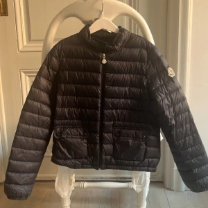 Monclear jacka - Säljer min super snygga monclear vår jacka som tyvärr är för liten. Den ha ringa skador och har använts under en sommar. Den är mörkblå och i storlek 12-152cm. 