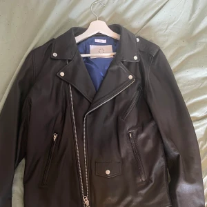 Skinnjacka 100% Skinn - Säljer min skinnjacka då jag bara använd den 1 gång sen jag köpte den (april). Inga märken eller fläckar, som ny i kvalité. Materialet är 100% skinn och innersidan är 100% polyester. Bekväm och rymlig