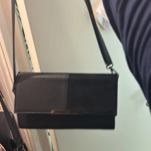Svart väska - Köpte den för flera år sedan men har aldrig haft användning för den då jag har många väskor som är liknande.