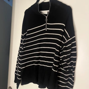Svartvit randig stickad tröja  - Stickad tröja med dragkedja svartvit randig storlek M, bra skick men använd 