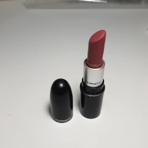 Mac läppstift TWING - Ett krämigt läppstift med mjuk känsla och uppbyggbar, medel- till heltäckande formula med satinfinish.   Mac läppstift i färgen Twing (satin) mini, använd 2-3 ggr bara. 1,8g  