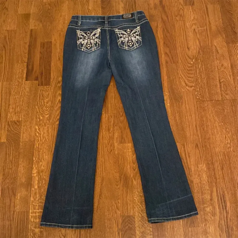 🤍Ett par supersnygga lågmidjade Earl Jean jeans med kors på bakfickorna. Byxorna är i bootcut och har Midjemått: 38cm rakt över och innerbenslängd: 78cm🤍. Jeans & Byxor.