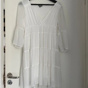 Klänning  - Vit klänning jag ärvt men är i jättebra skick. Jag själv aldrig använt den. Ärmarna är trekvartslånga och den går över knäna på mig som är 165 cm 