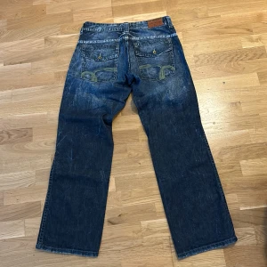 Vintage Baggy Hilfiger Jeans - ”Hilfiger denim” med snygga detaljer och bra fade i baggy passform. 34/34, Midja: 43cm & Inseam: 83cm.                                                Skriv för bilder/mått/frågor, billigare vid köp av flera plagg!